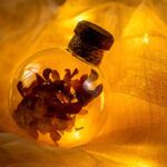 Magic bottle filled with dry flowers in amber light